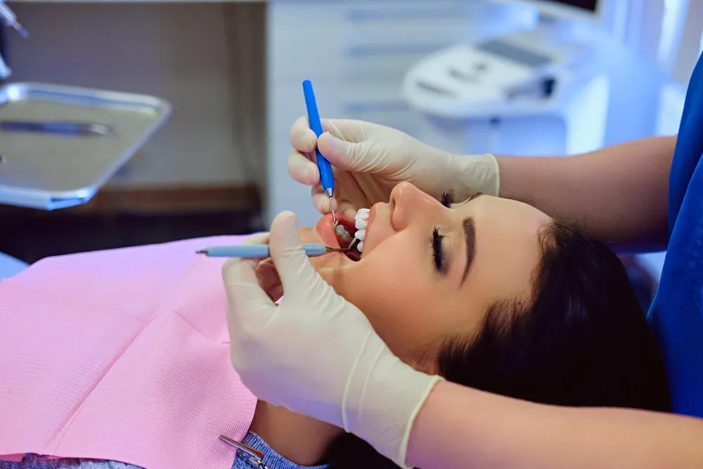 Dentist treating a patient in the dental chair